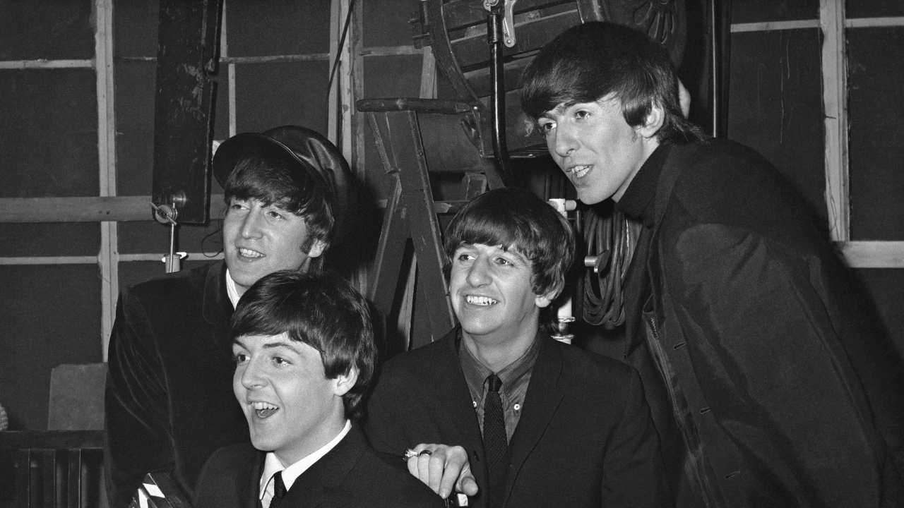 The Beatles smiling on set